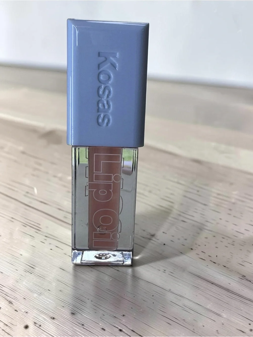 Kosas Gloss in Nude Beige with Lavender Cap